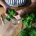 unrecognizable-woman-indoors-at-home-cutting-gree-2022-02-02-03-58-32-utc